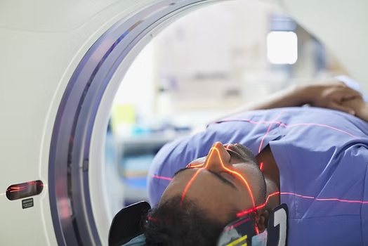 Person Lying in CT Scan Machine — NatureWise Pest Control In Port Macquarie, NSW