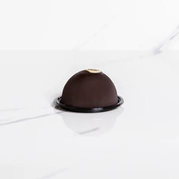 Cupola monoporzione al cioccolato su una superficie di marmo bianco