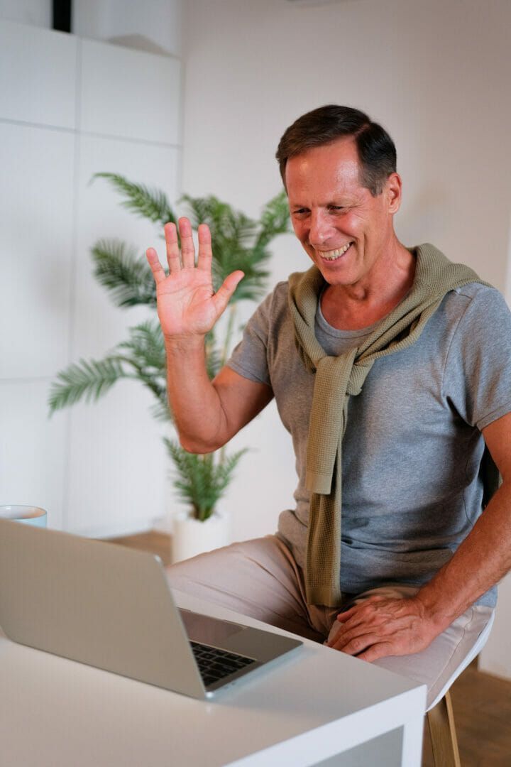mature man recording a video on his laptop