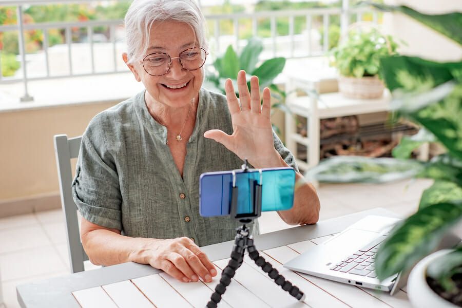 senior woman influencer recording a video with her smart phone
