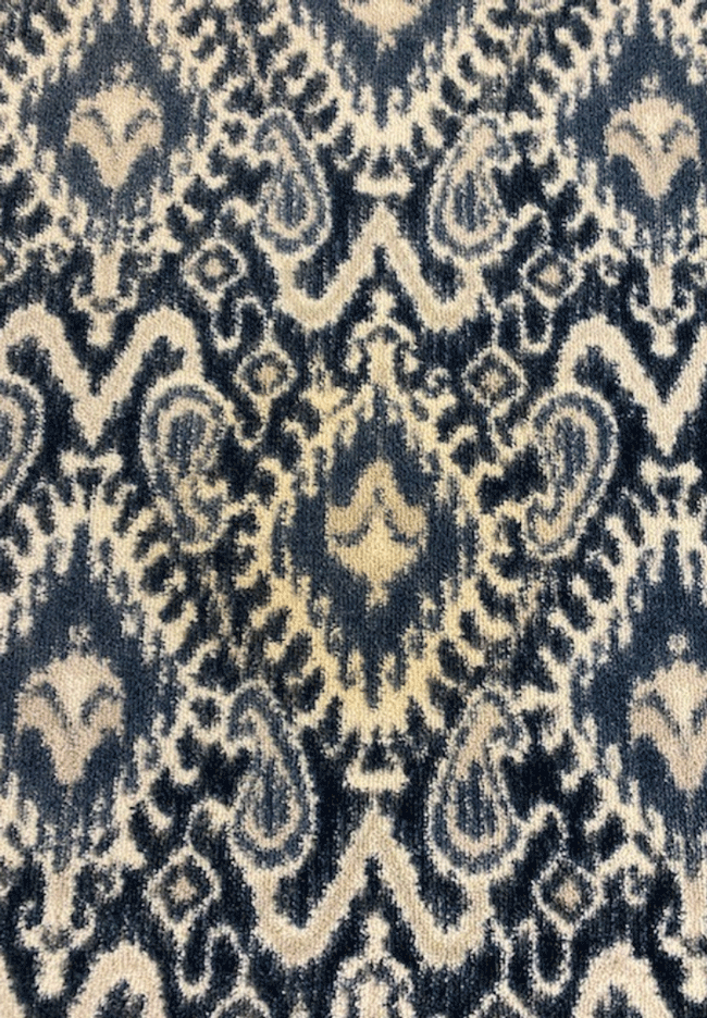 A close up of a blue and white rug with a pattern on it.