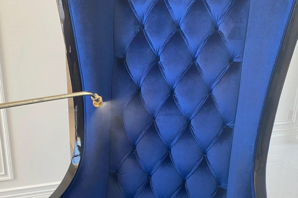 A person is cleaning a couch with a spatula