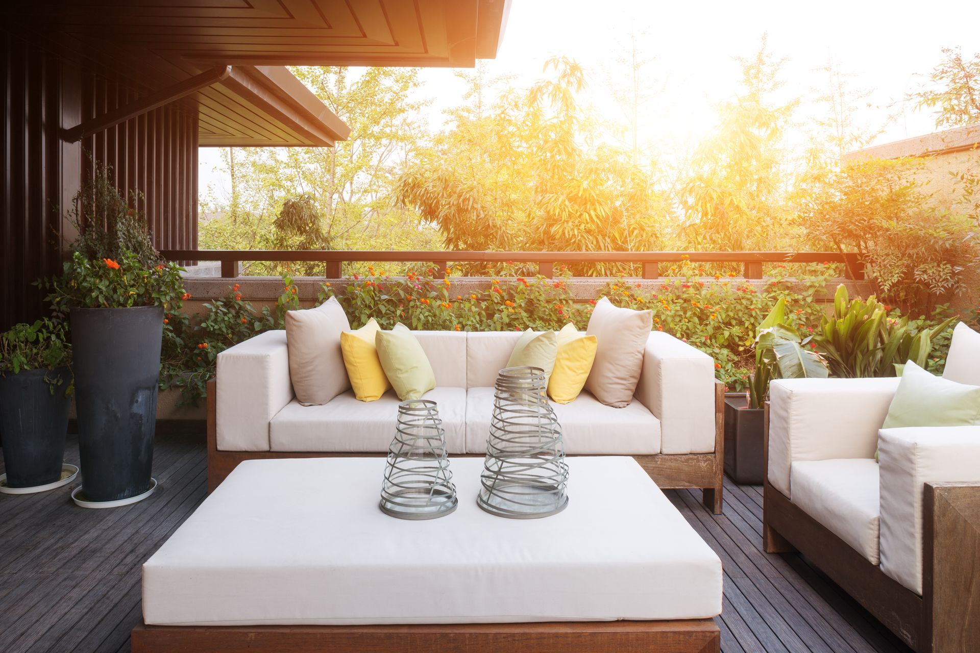 A patio with a couch , chairs , and a table.