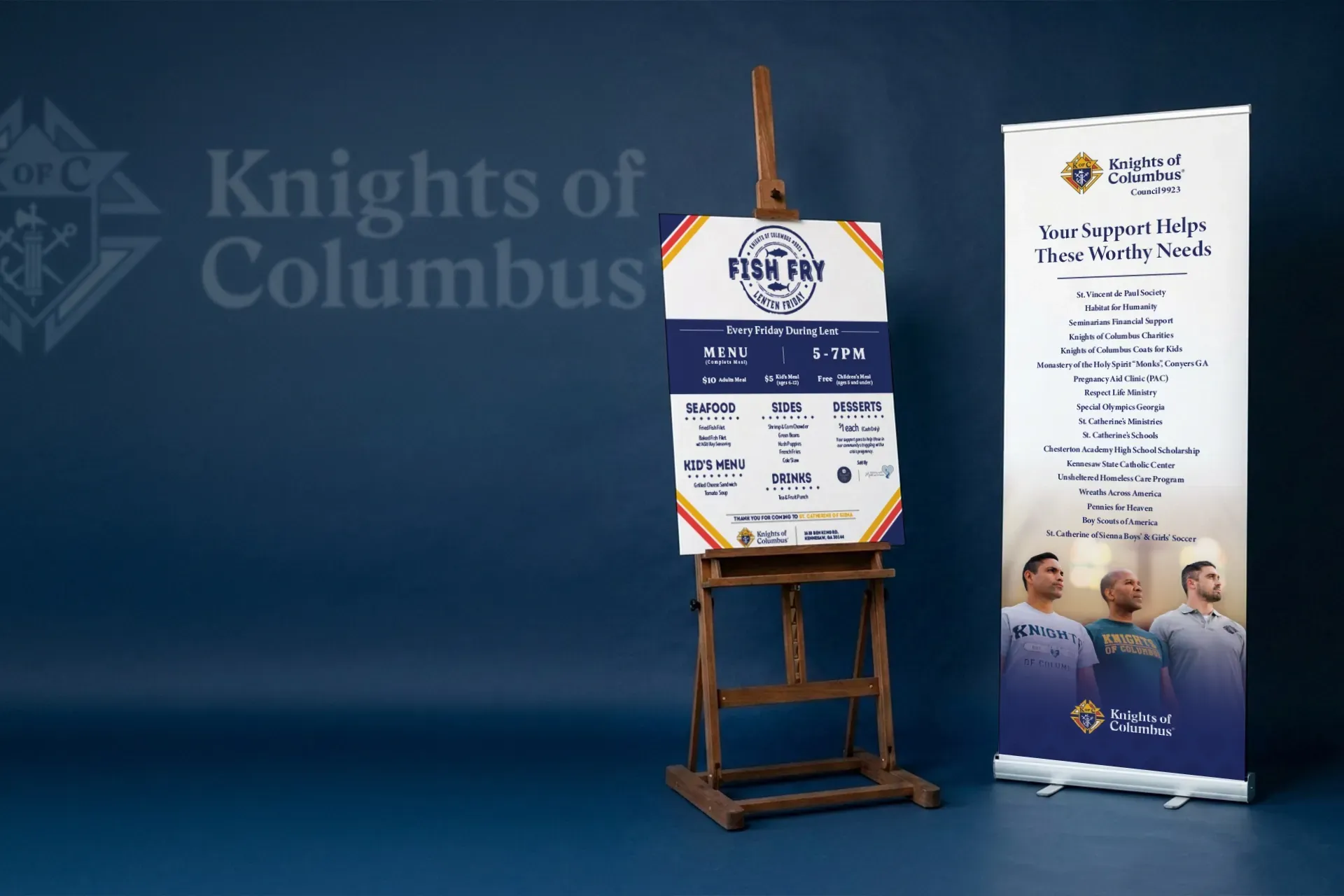 Knights of Columbus event sign display with posters on wooden easels against a blue background
