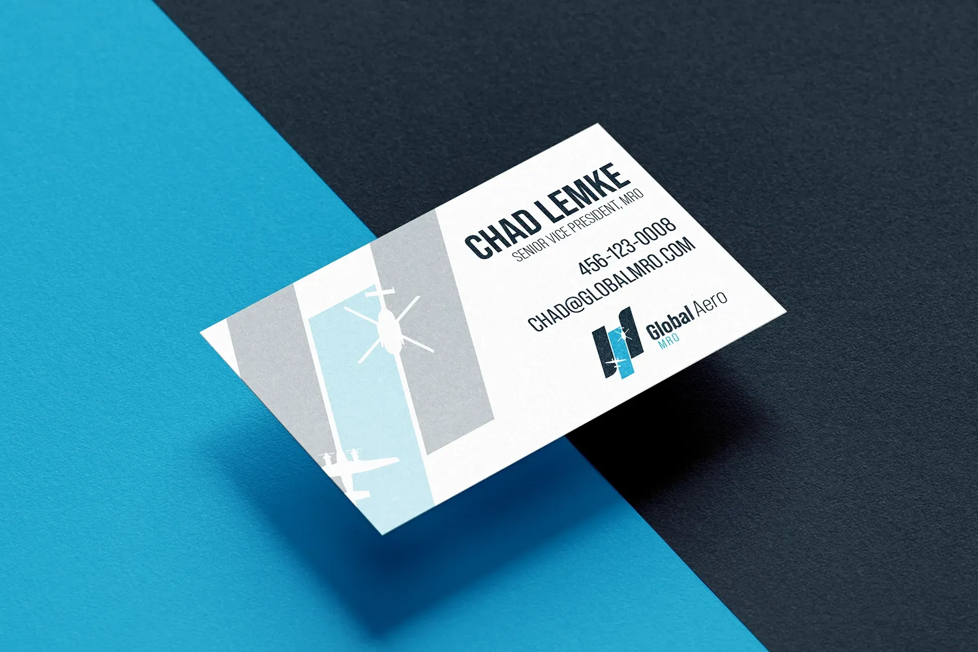 Business card on a blue and dark background, featuring a light geometric design and logo.