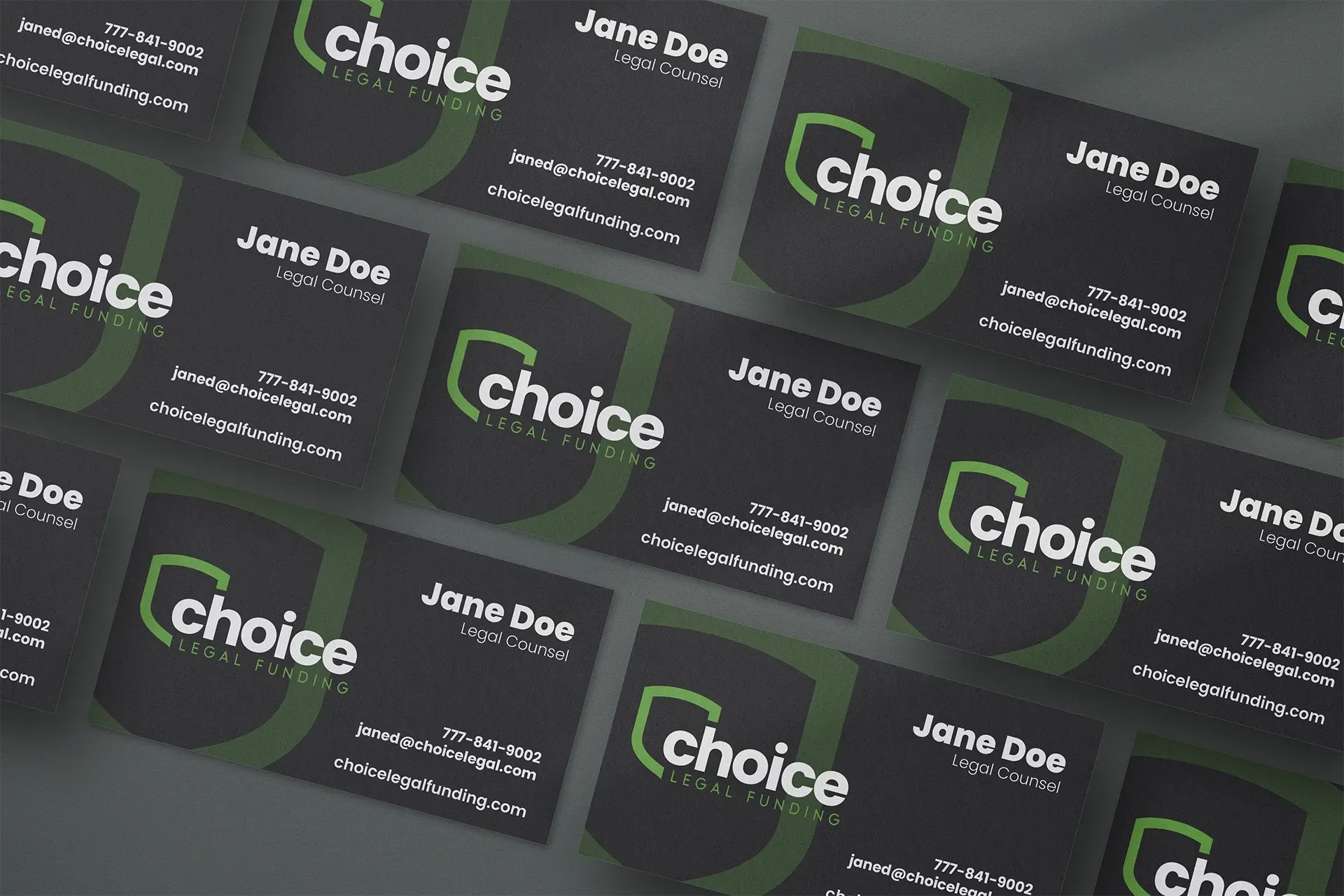 Stack of black and green business cards reading “Choice” and “Jane Doe” on a dark surface