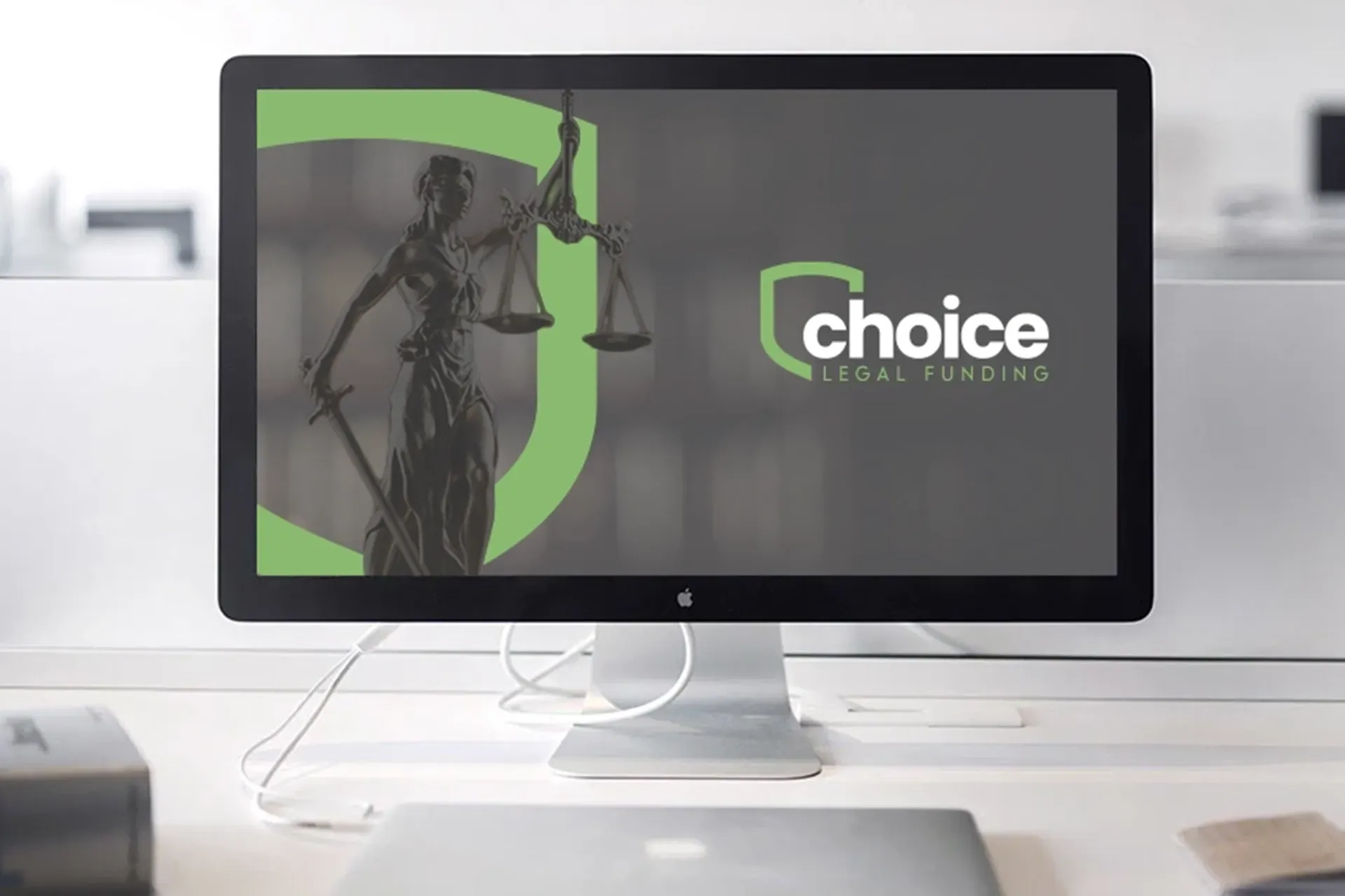 Desktop monitor displaying a Choice logo on a dark screen in a white office setting