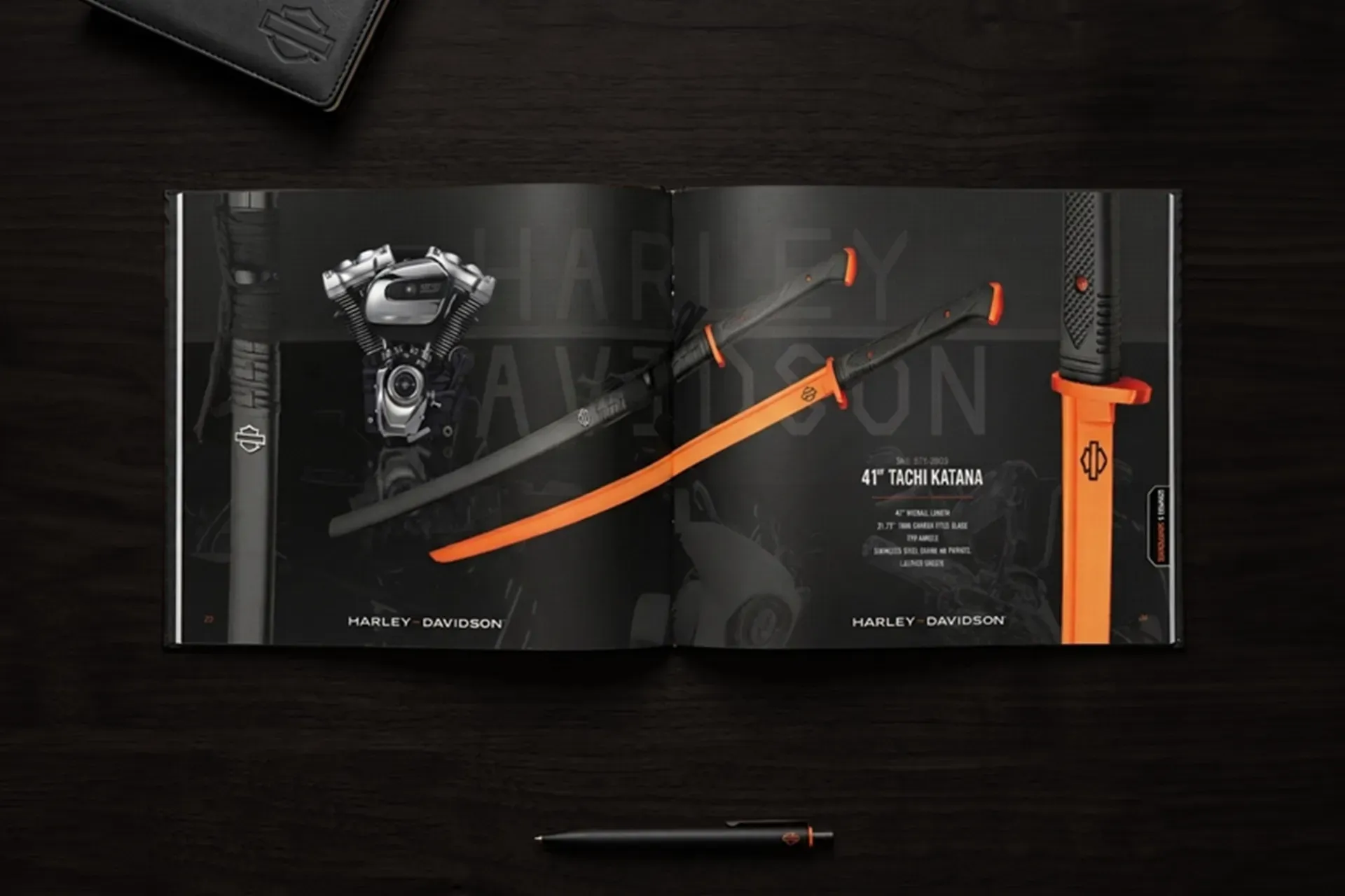 Black and orange watch, knife, and pen gift set in a presentation box on a dark surface
