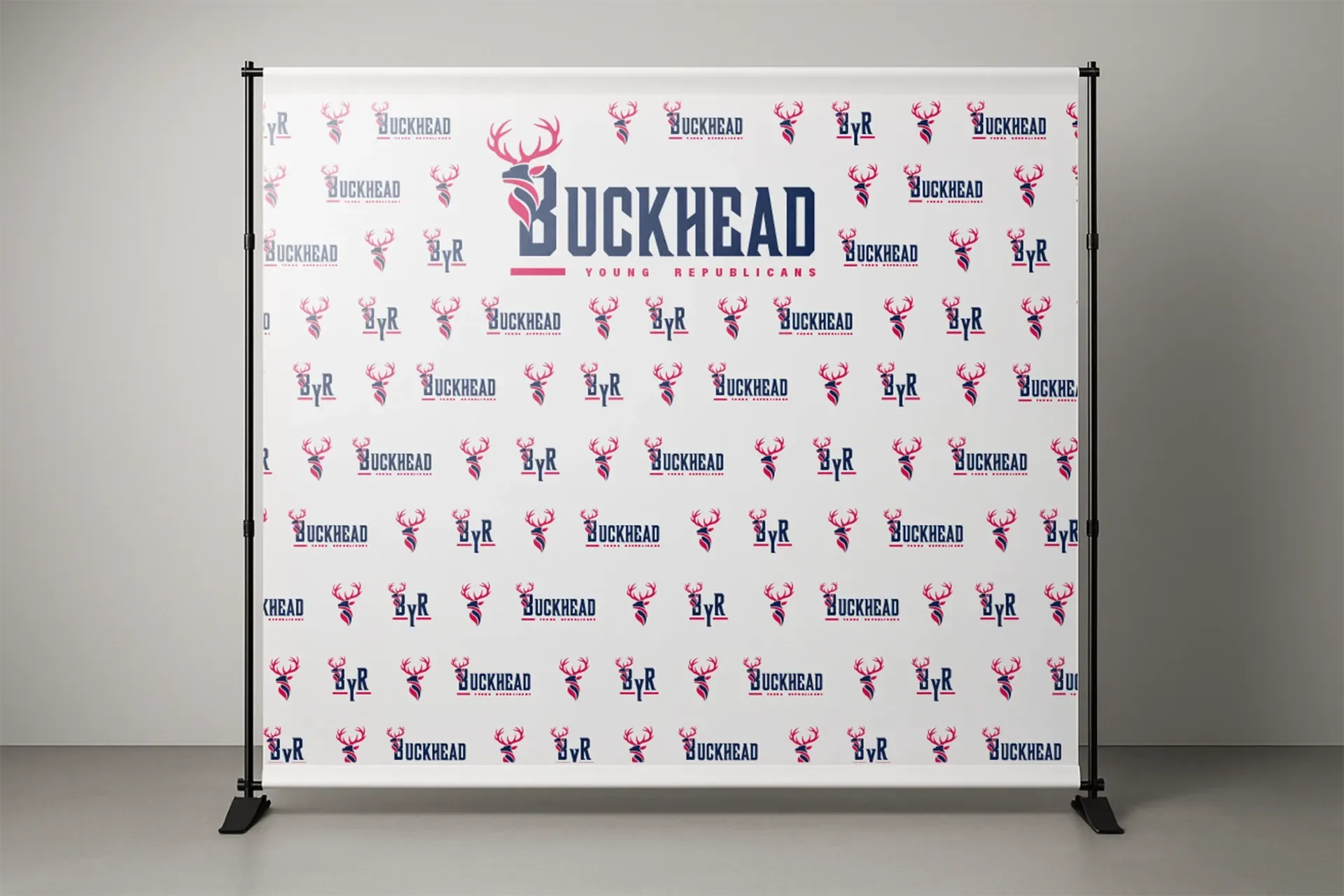 Step-and-repeat Buckhead backdrop on a stand with white background and blue-red logos
