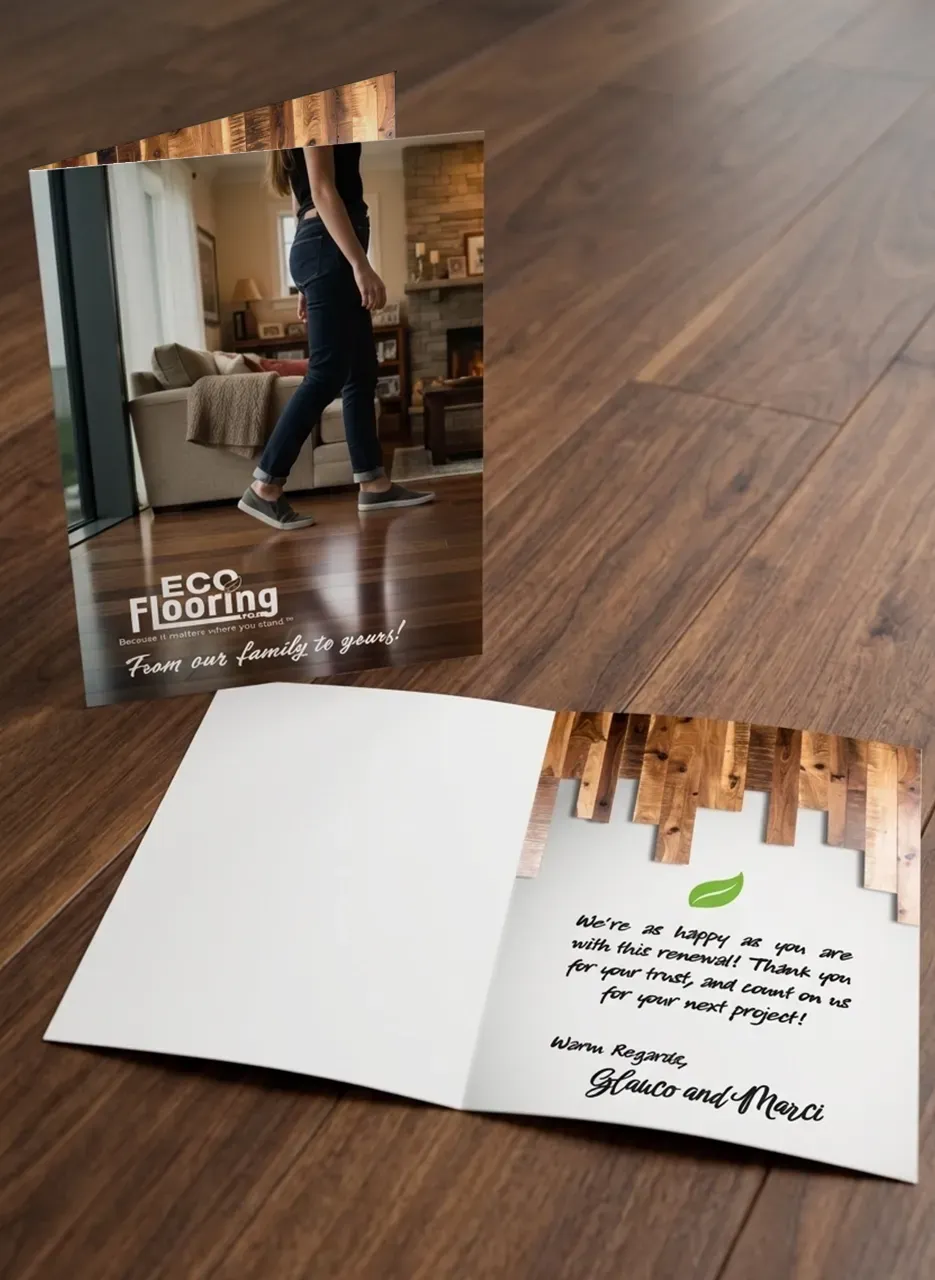 Wood flooring brochure on wood floor, showing a person and handwritten note inside the open pamphlet