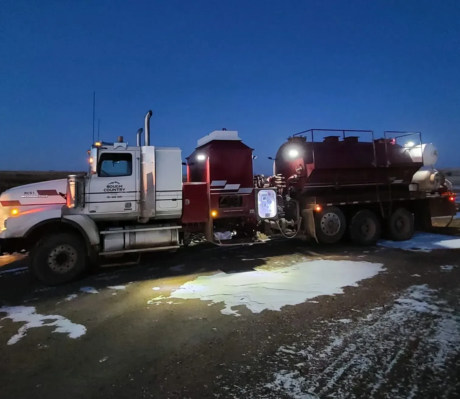 A tanker truck is driving down a highway.