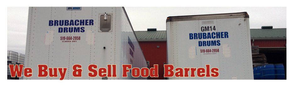 Two white trailers that say brubacher drums are parked in front of a building