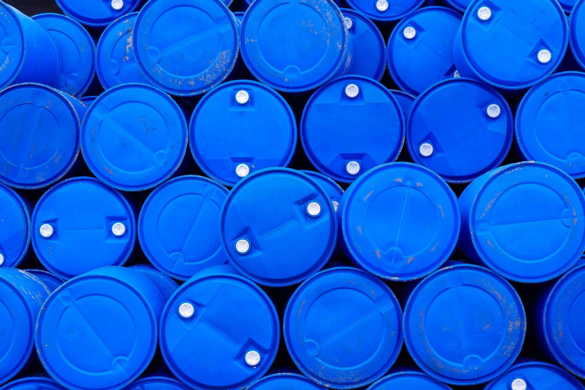 Stacked blue industrial barrels viewed from above