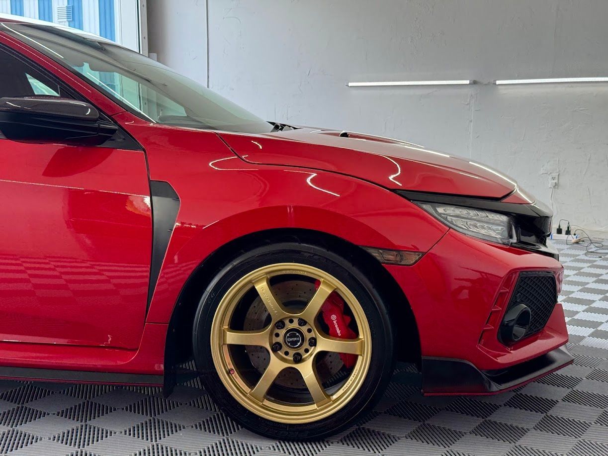 Red Honda Civic Type R with gold wheels.