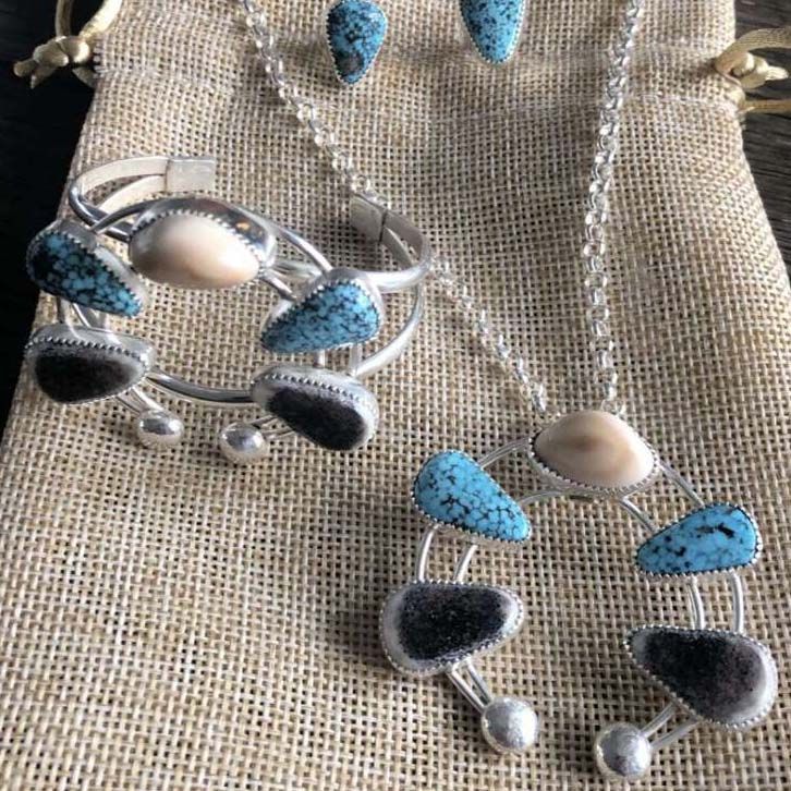 A bracelet necklace and earring set with turquoise stones