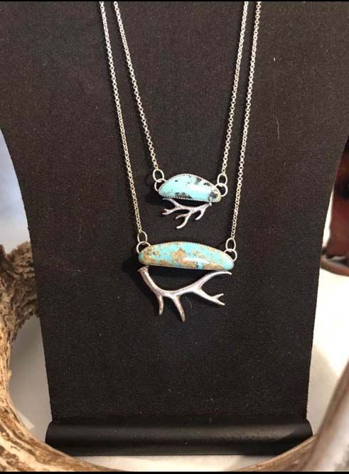 Two necklaces with turquoise and antlers on a mannequin