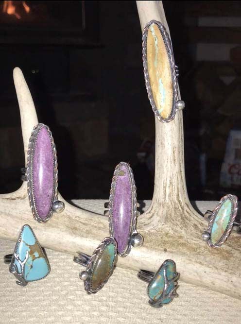 A group of rings are sitting on a piece of deer antlers