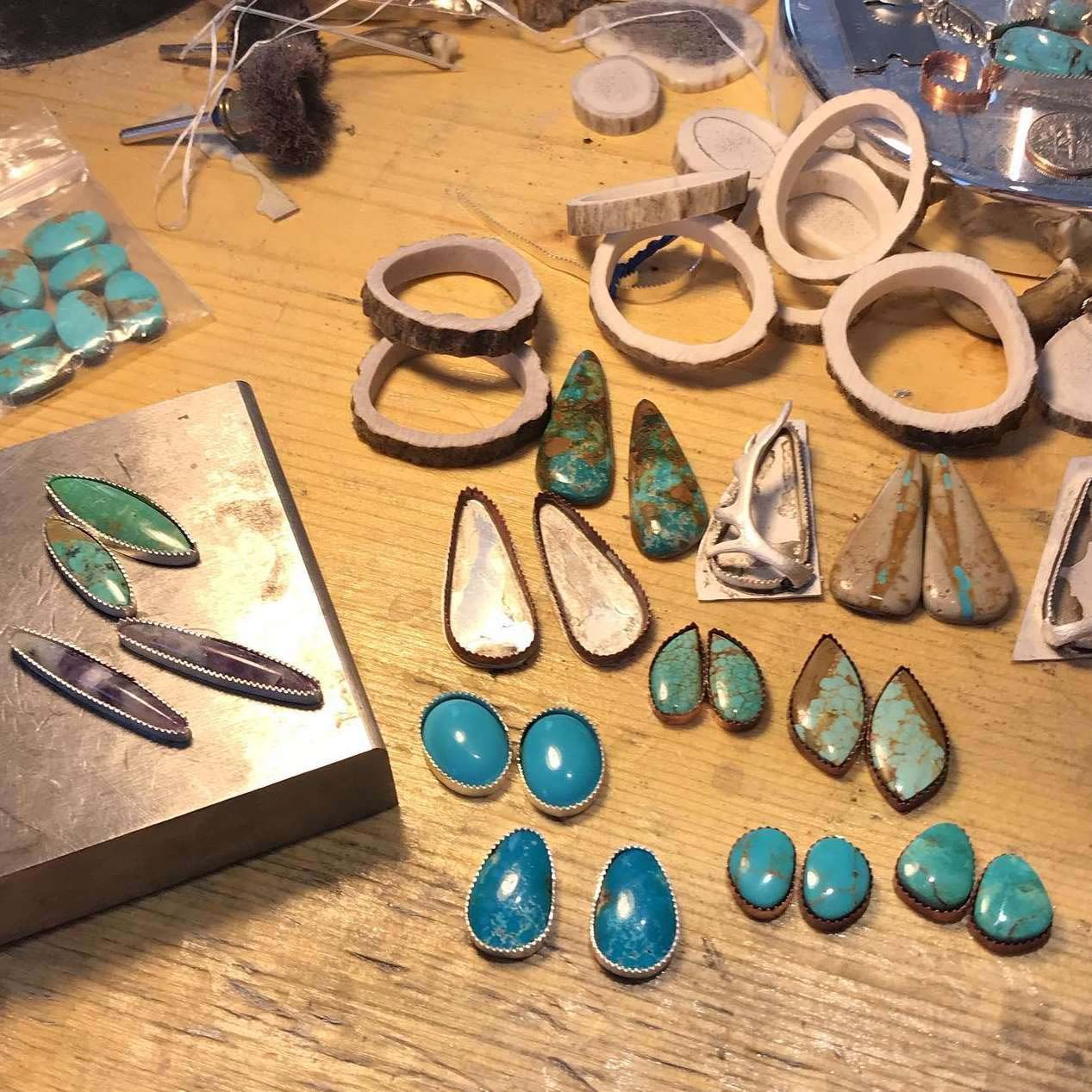 A table with a lot of turquoise beads on it
