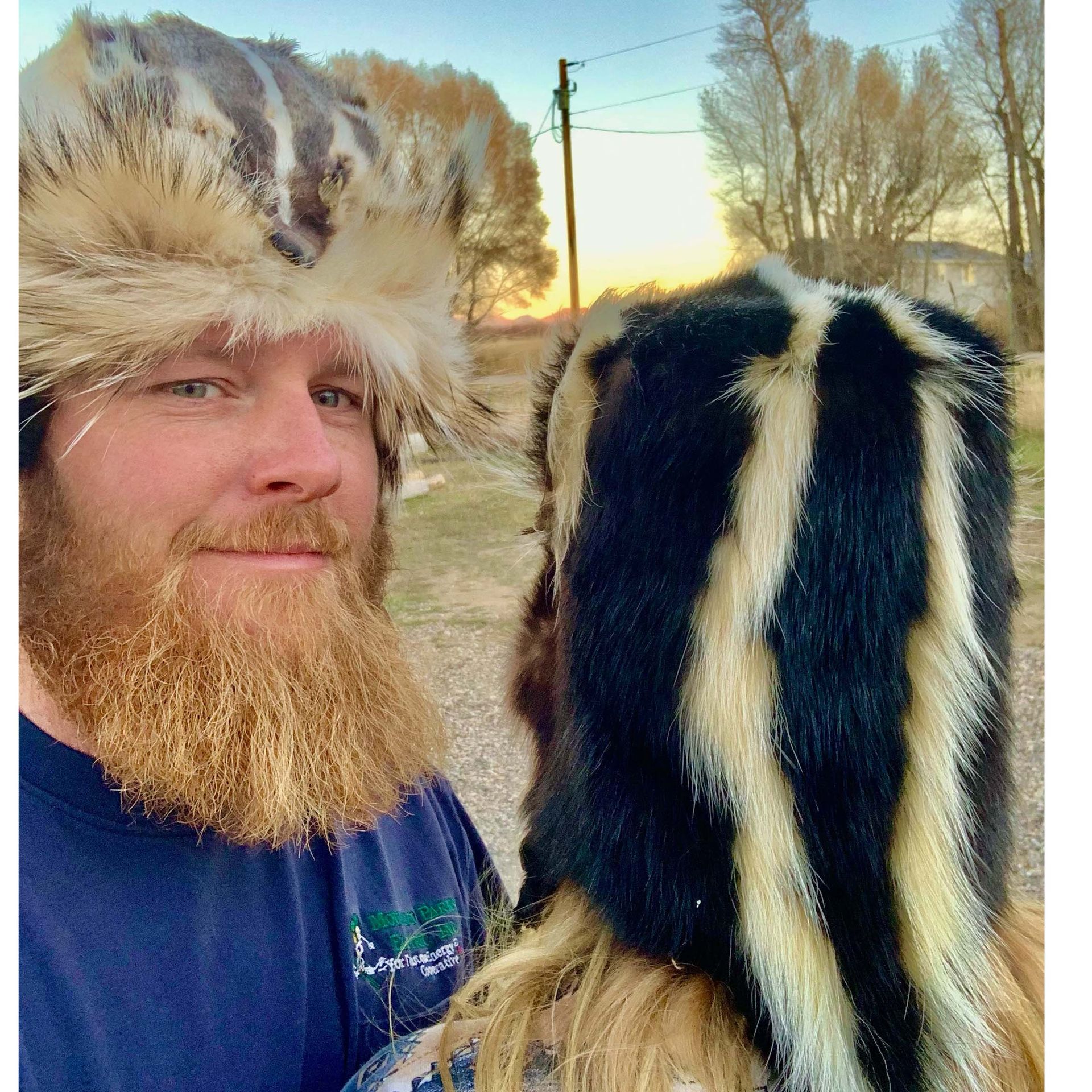 A man with a beard is wearing a fur hat