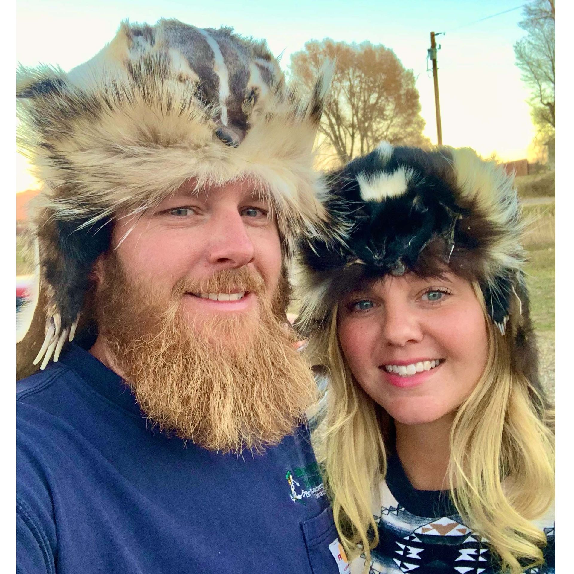 A man with a beard and a woman wearing fur hats
