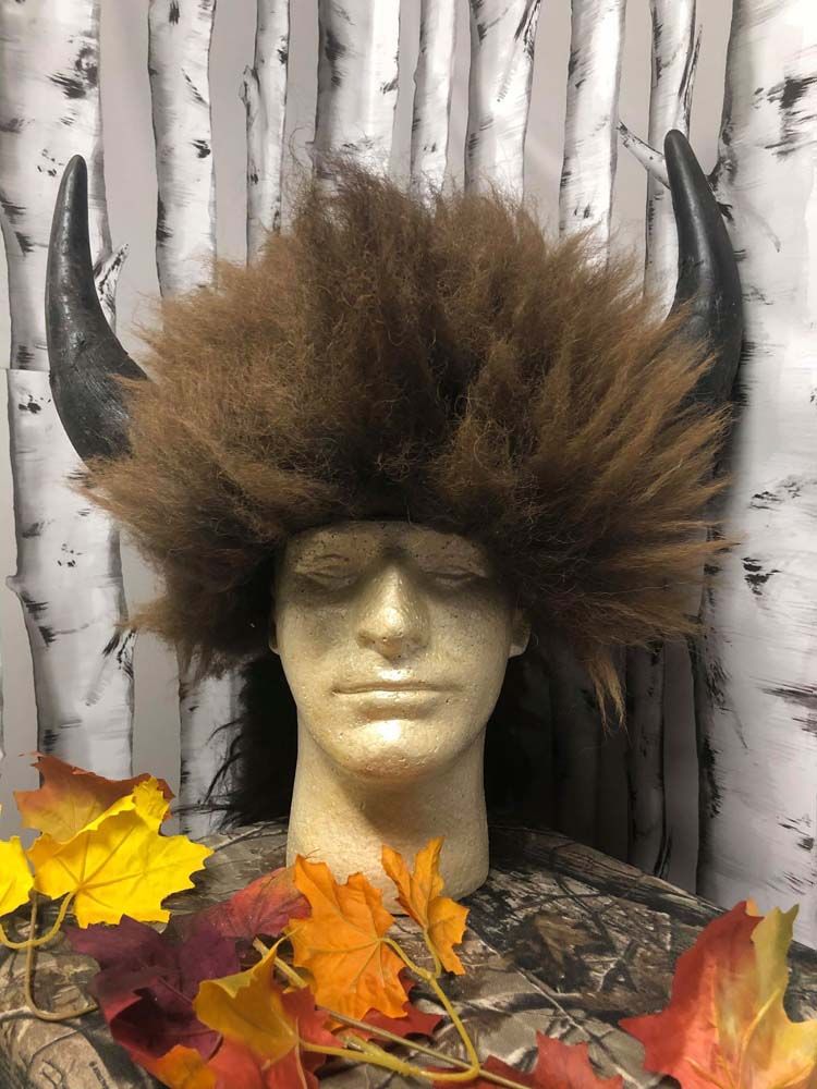 A mannequin head wearing a buffalo wig with horns.