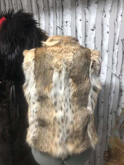 A close up of a fur vest on a mannequin.