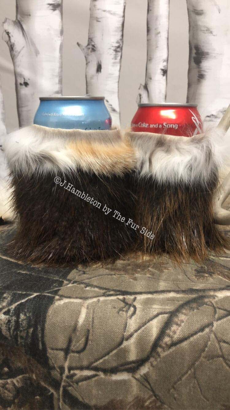 Two cans of soda are sitting on top of a furry stool.