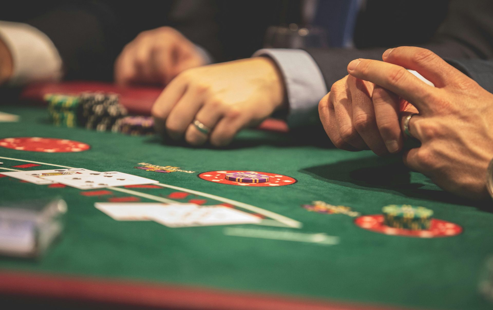 A group of people are playing a game of poker at a table.