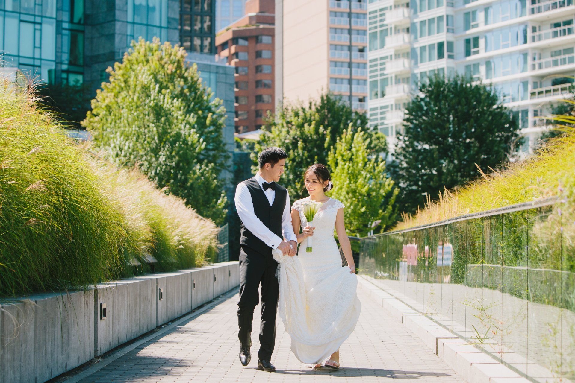 Bride and groom walking down the seawall