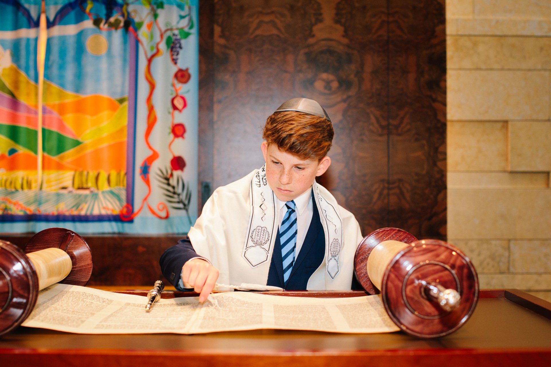 A young Jewish boy reading a scroll
