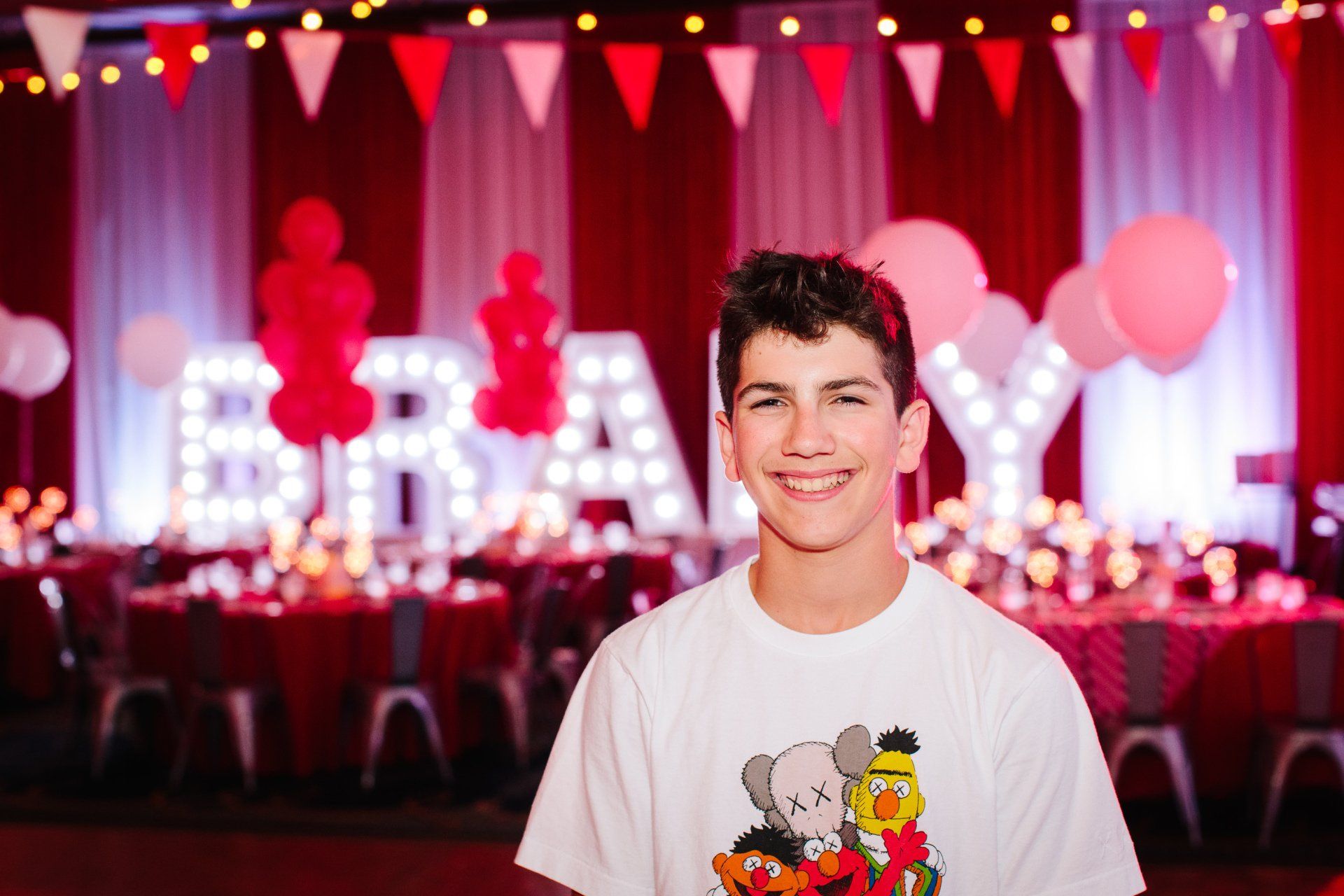 A boy smiling at his bar mitzvah event