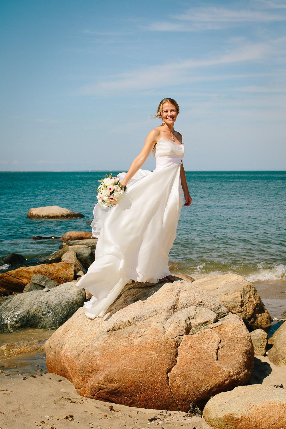 Bride enjoying the breeze by the sea