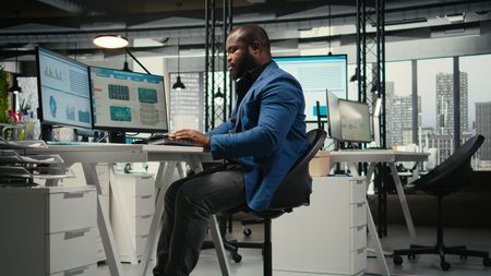 Vault Technologies IT professional working at a computer in a modern office
