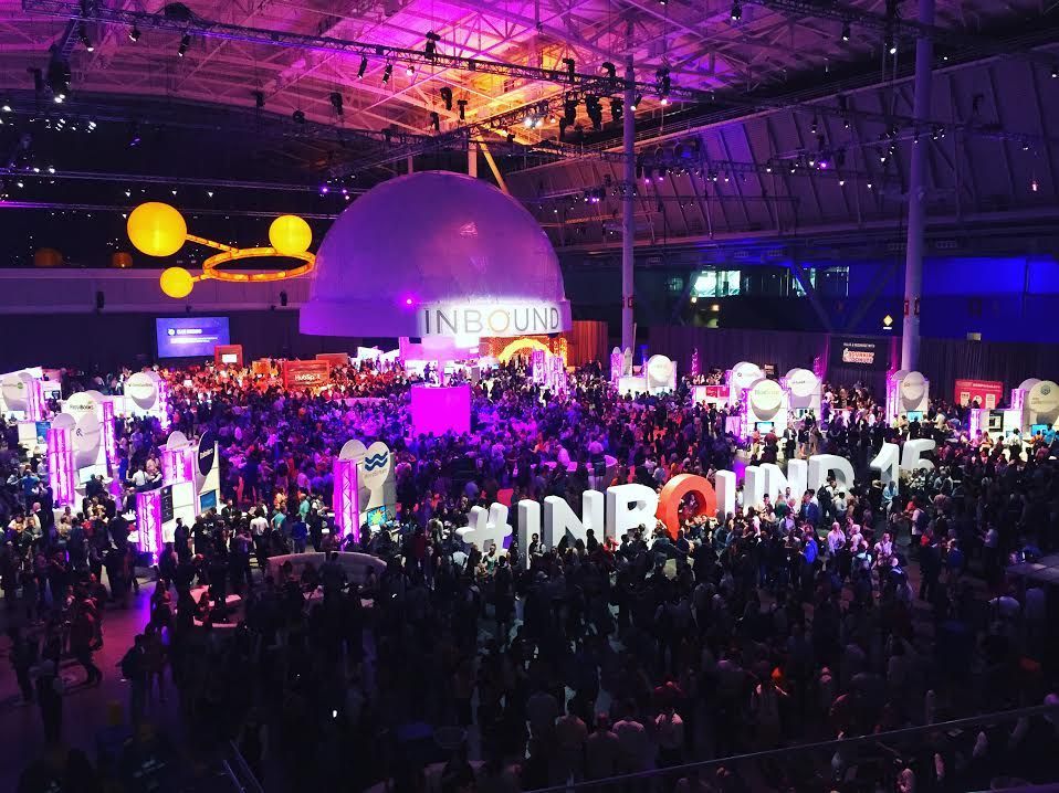 Large crowd at the Inbound 15 conference, with the event's name in large letters and colorful lighting.
