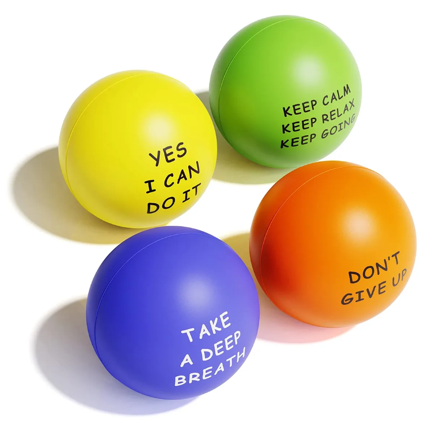 Four colorful stress balls with motivational phrases: yellow, green, orange (