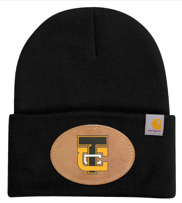 Black knit beanie with a tan oval patch and gold-black logo on the front