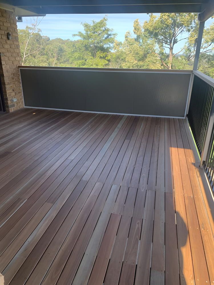 A Wooden Deck With A Fence And Trees — Hunter Home Services in Rutherford, NSW