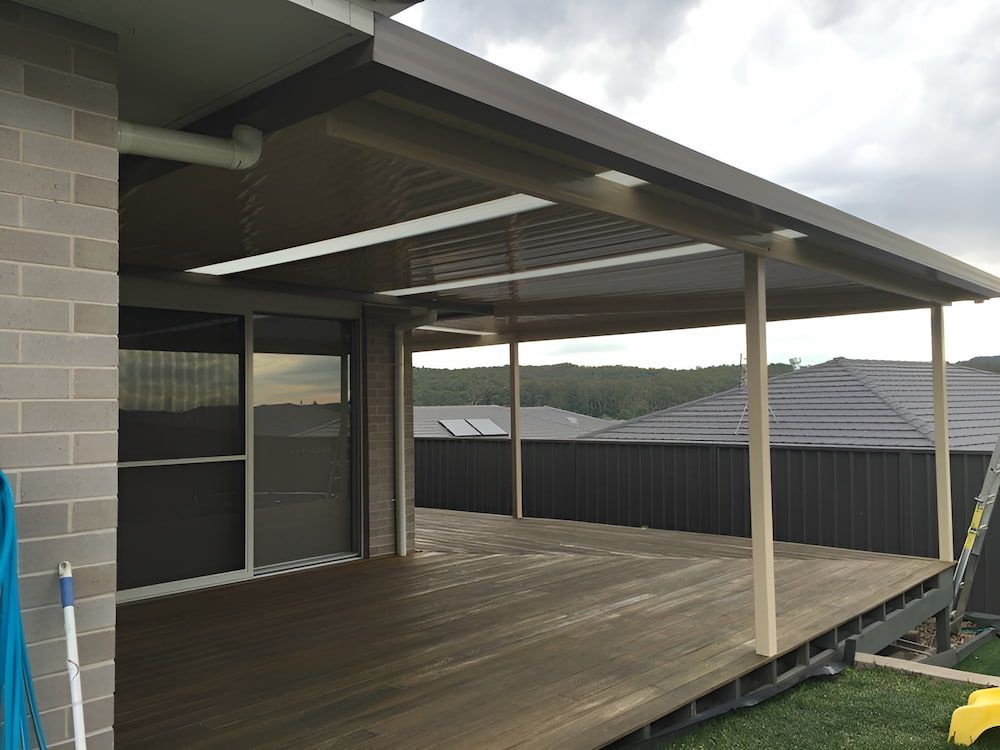 A House With A Wooden Deck And A Canopy Over It — Hunter Home Services in Fletcher, NSW