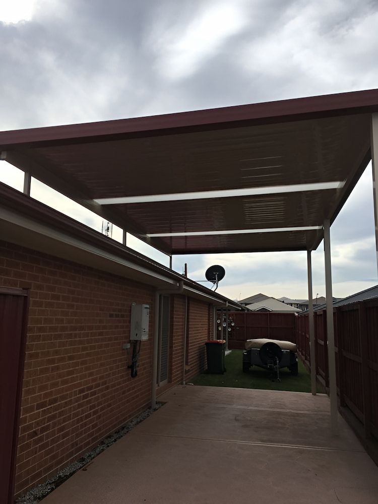 A Brick House With A Carport Underneath It — Hunter Home Services in Thornton, NSW