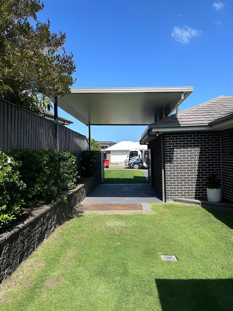 There Is A Carport In The Backyard Of A House — Hunter Home Services in Fletcher, NSW