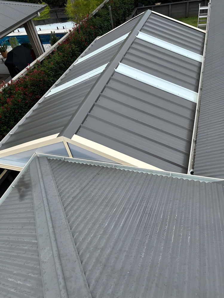 An Aerial View Of A Gray Roof With White Skylights — Hunter Home Services in Newcastle, NSW