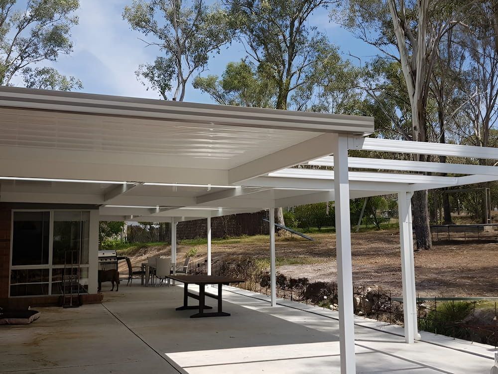 A White Pergola With A Table Underneath It — Hunter Home Services in Huntlee, NSW