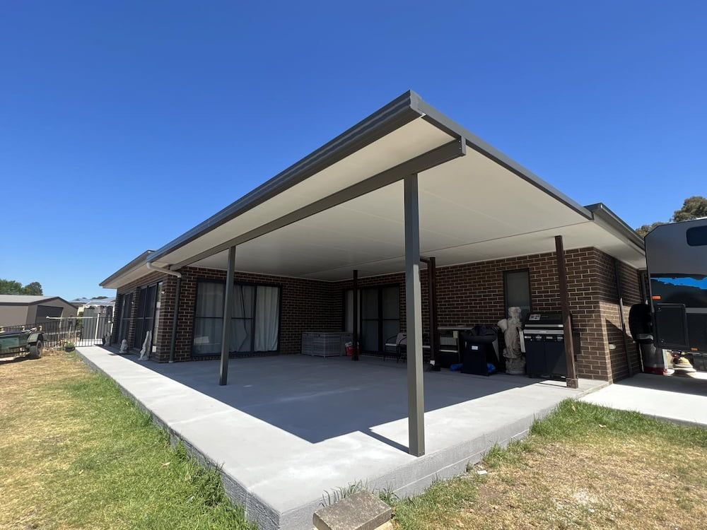 A House With A Covered Patio And A Caravan Parked In Front Of It — Hunter Home Services in Hunter Valley, NSW