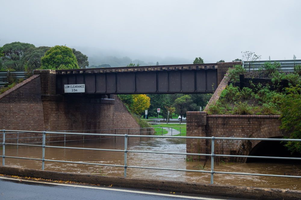 A Bridge Over a River that Is Flooded with Water — Leisure Coast Powder Coaters in Mittagong, NSW
