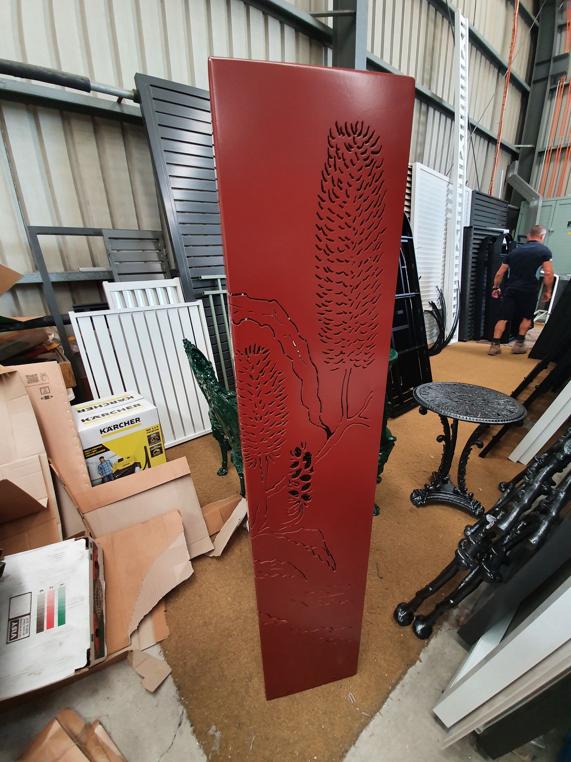 A Red Wall with A Leaf Design on It Is in A Warehouse — Leisure Coast Powder Coaters in Unanderra, NSW