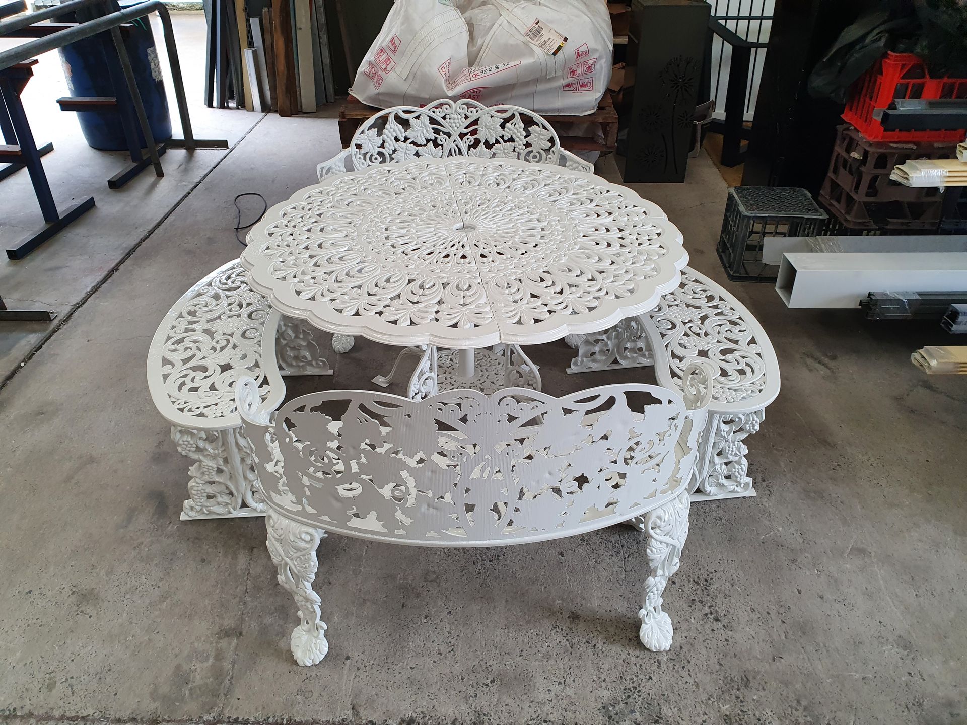 A White Table and Chairs Are Sitting on A Carpet in A Room — Leisure Coast Powder Coaters in Unanderra, NSW