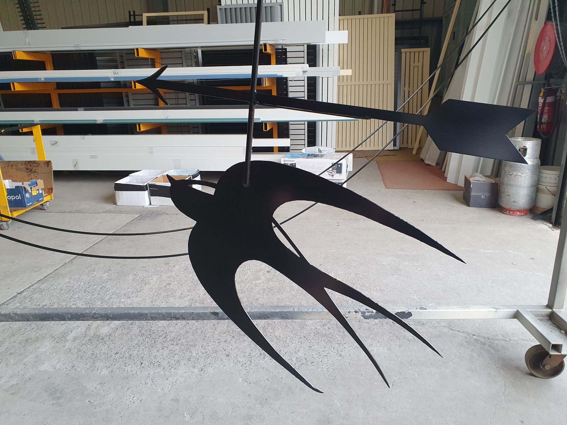 A Silhouette of A Bird Is Hanging from A Wire — Leisure Coast Powder Coaters in Unanderra, NSW