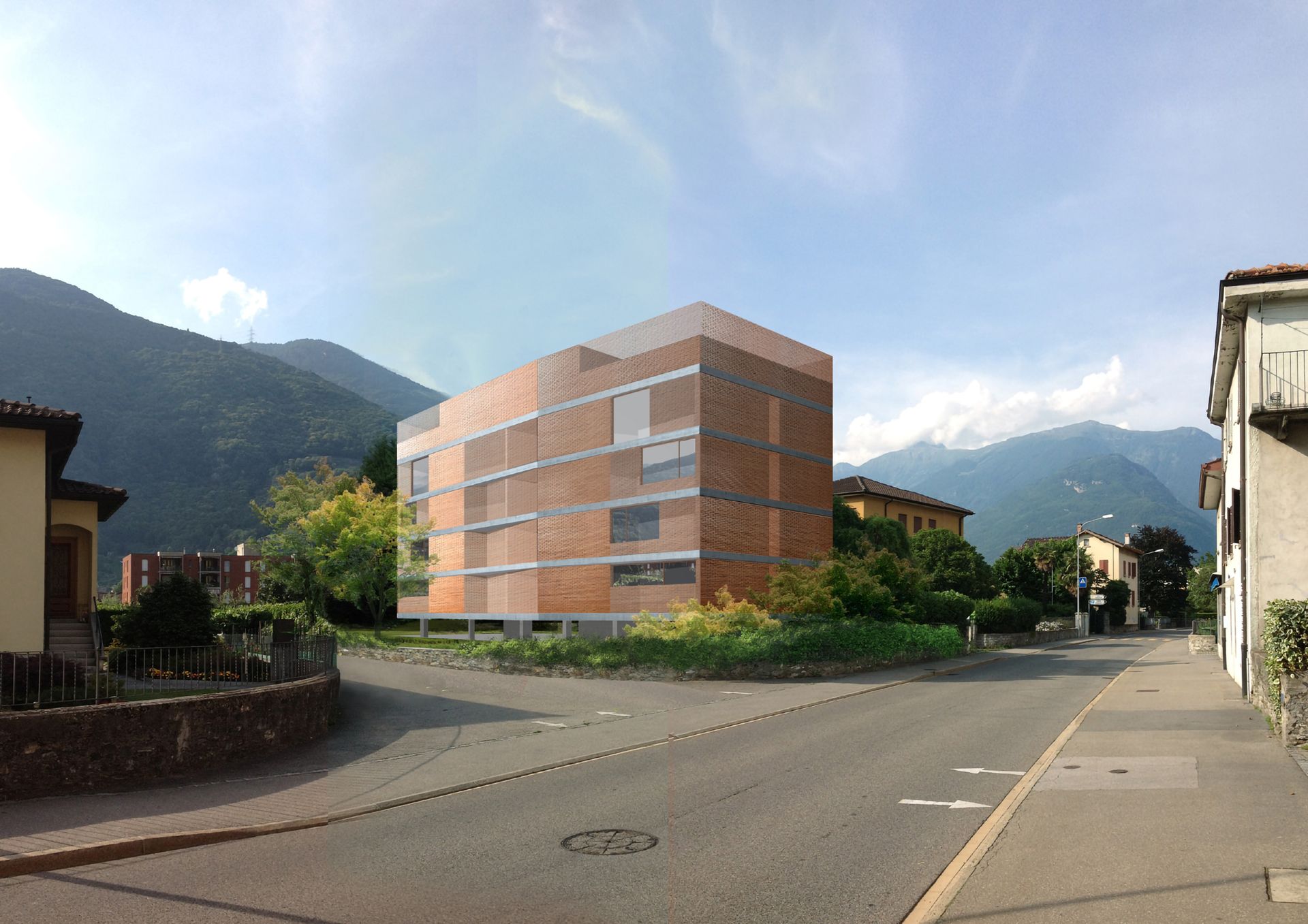 Moderno edificio in mattoni rossi all'angolo di una strada, con le montagne sullo sfondo. Giornata di sole.