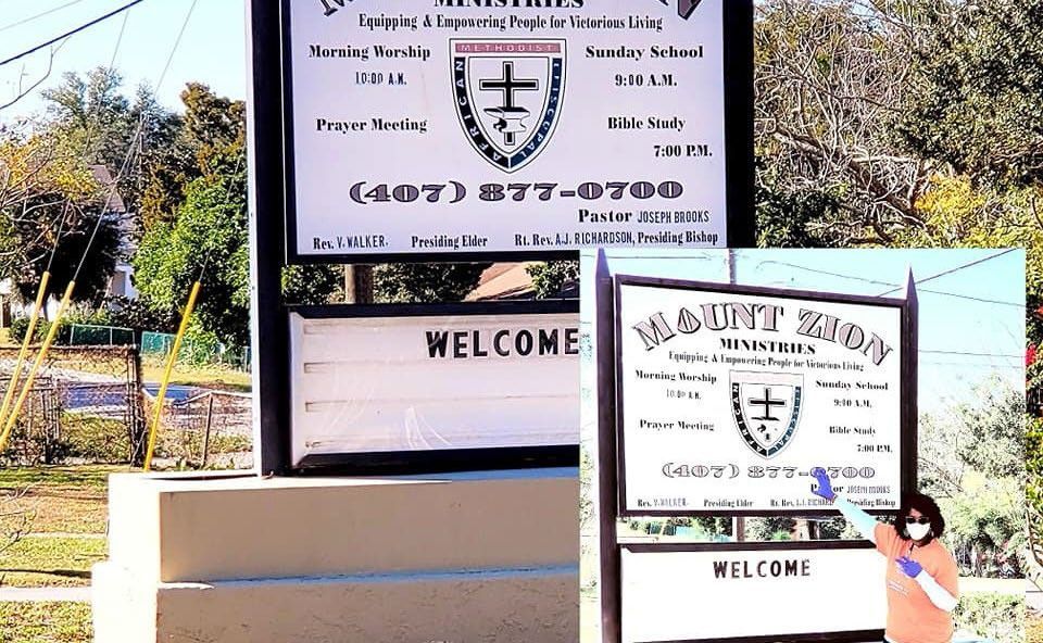 Sign for Mount Zion Ministries, white with black text, a church welcome.