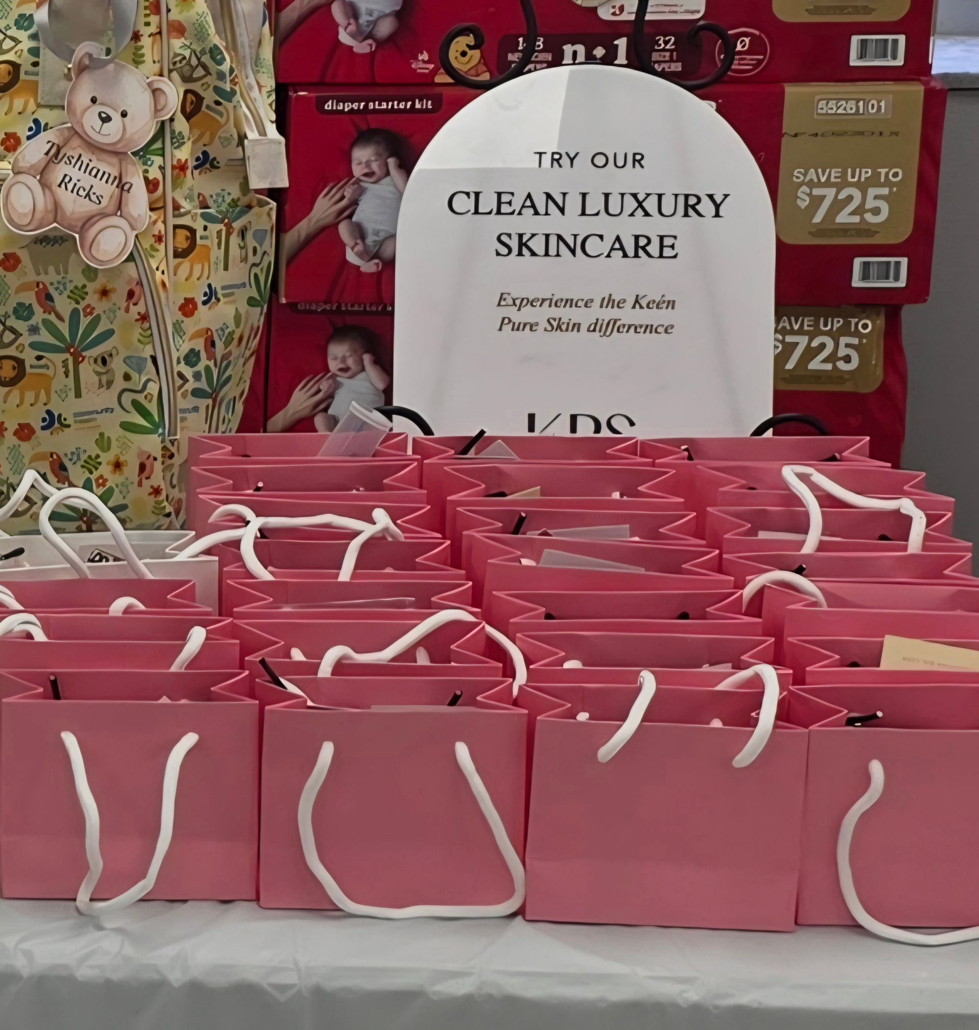 Pink shopping bags displayed in a store with a sign for “Clean Luxury Skincare” and sale price tags.